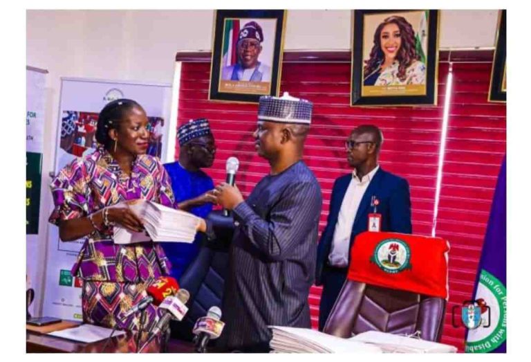 Prof Fatima Waziri-Azi presenting some documents to Mr James Lalu during the visit to NCPWD.