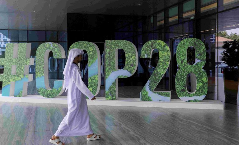 A person walks past a "#COP28" sign during The Changemaker Majlis, a one-day CEO-level thought leadership workshop focused on climate action, in Abu Dhabi, United Arab Emirates, October 1, 2023. REUTERS/Amr Alfiky/File Photo Acquire Licensing Rights