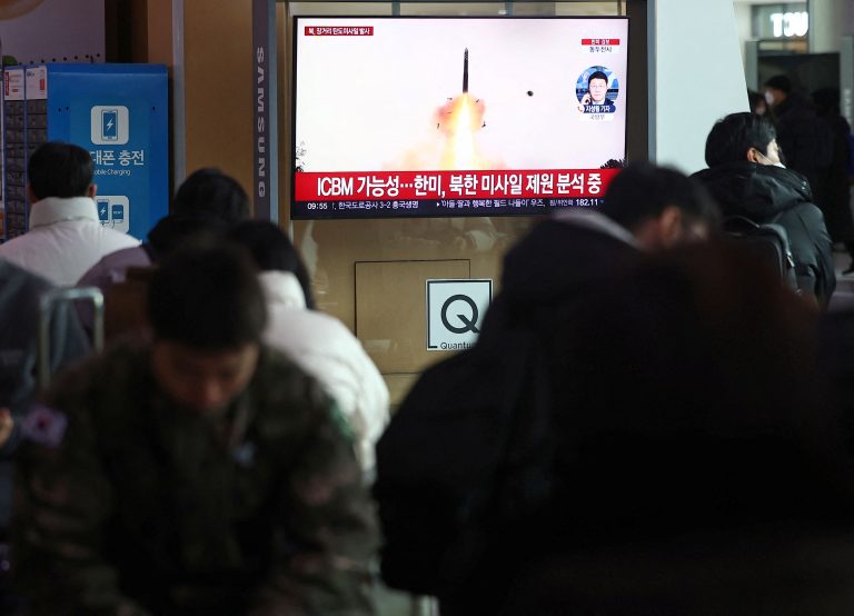 People watch a TV broadcasting a news report on North Korea firing what appeared to be a long-range ballistic missile, at a railway station in Seoul, South Korea, December 18, 2023. Yonhap via REUTERS