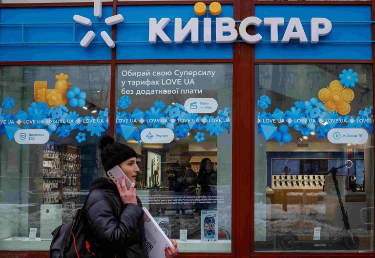 A woman walks past a store of Ukraine's telecommunications company Kyivstar, amid Russia's attack on Ukraine, in Kyiv, Ukraine December 12, 2023. REUTERS/Alina Smutko/File Photo
