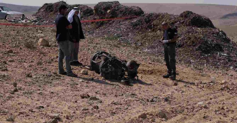 A police officer and residents inspect the remains of a rocket booster that, according to Israeli authorities critically injured a 7-year-old girl, after Iran launched drones and missiles towards Israel, near Arad, Israel, April 14, 2024. REUTERS/Christophe van der Perre