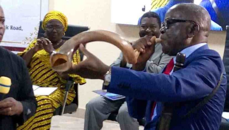 Ortom blowing the bull horn presented to him by Dr Sebastine Agbinda for advocacy against open grazing and killing of Benue people.