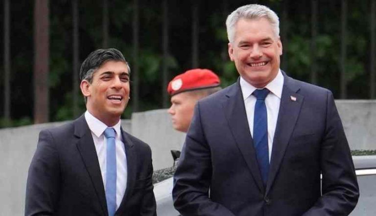 Austrian Chancellor Karl Nehammer (right) welcomes Britain's Prime Minister Rishi Sunak (left) as he arrives for talks during an official visit to Austria, in Vienna, on May 21, 2024.