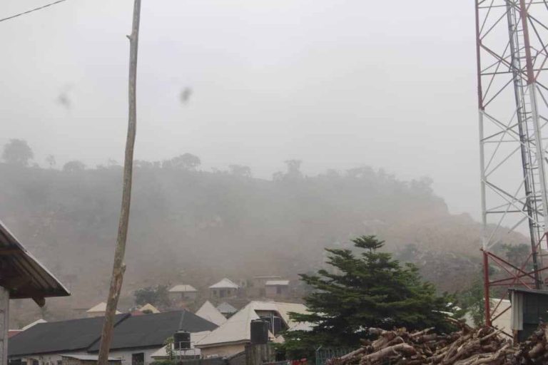 Bmuko Community beclouded in thick haze of dust and smoke minutes after blasting activity by Istanbul Concrete Ltd. This picture was taken several meters away from the scene of blast.