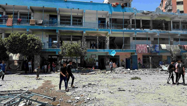 Dozens Reported Killed In Strike On Gaza School That Israel Says Targeted Hamas Palestinians inspect the site of an Israeli strike on a UNRWA school sheltering displaced people