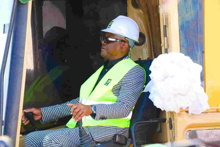 Wike piloting a construction vehicle.