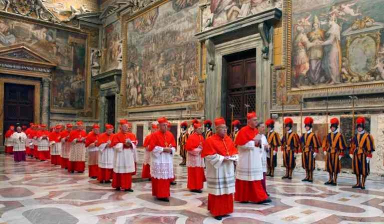 In this photo from April 18, 2005, cardinals walk to the Sistine Chapel at the Vatican at the beginning of the conclave that elected Benedict XVI a day later [File: Osservatore Romano/AP]