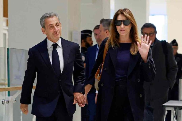 Former French President Nicolas Sarkozy arrives with his wife Carla Bruni-Sarkozy for the verdict in his trial.