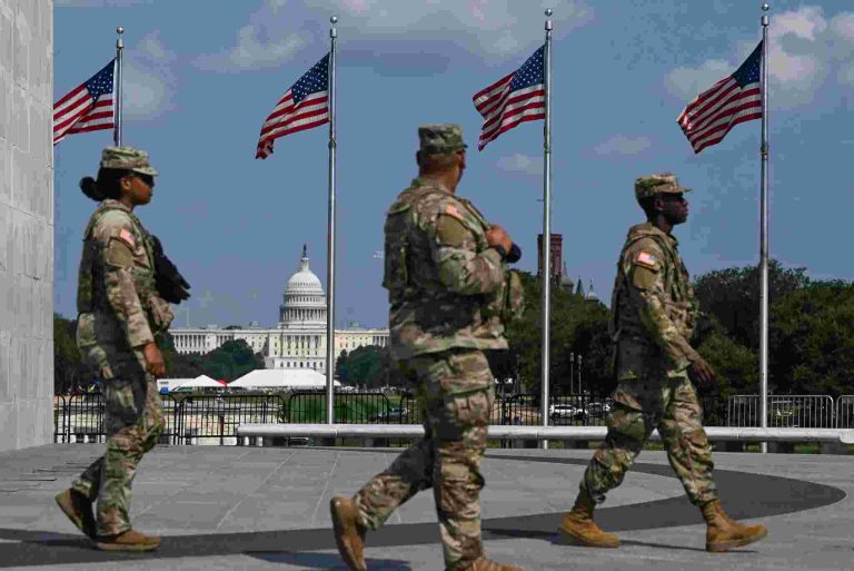 National Guard members patrolling the National Mall in Washington, D.C., last month. The dome of the National Capitol is in the distance. Credit...Kenny Holston/The New York Times
