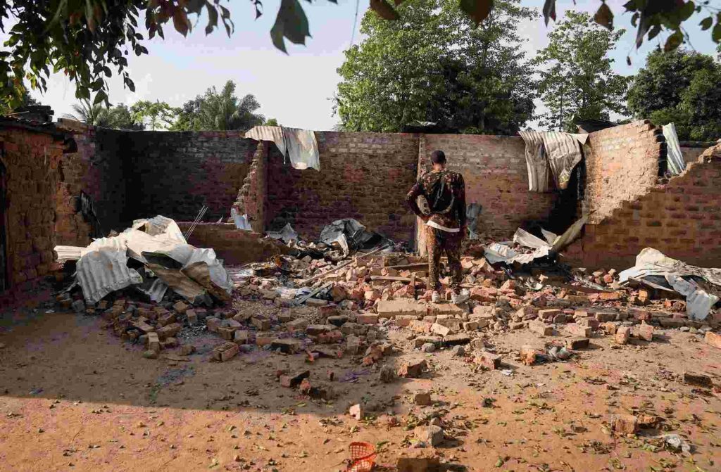 A man stands in front of a damaged and burnt house following a deadly gunmen attack in Yelwata, Benue State, Nigeria, June 16, 2025. REUTERS/Marvellous Durowaiye/File Photo