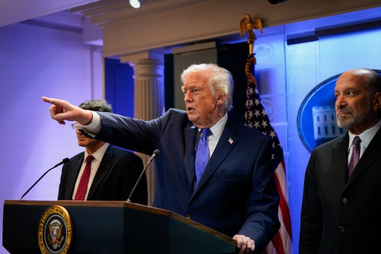 Trump flanked by Secretary of Commerce, Howard Lutnick.