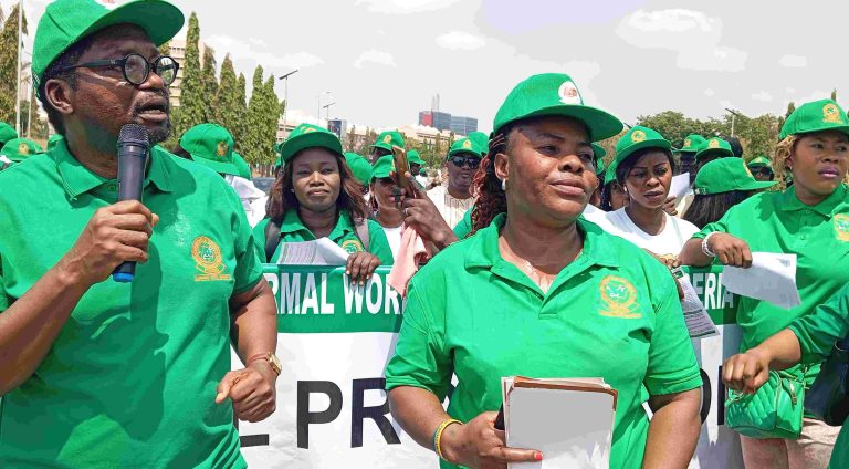 Comrade Komolafe, General Secretary, FIWON, with microphone during the protest at NASS, Abuja on Wednesday, March 25, 2026.