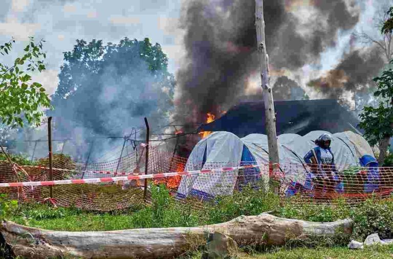 Congo Protesters Set Fire To Ebola Treatment Tents In Dispute Over Victim’s Body A Congolese police officer stands guard at a burning Ebola treatment center in Rwampara, outside Bunia, Ituri province, Democratic Republic of Congo, May 21. REUTERS/Gradel Muyisa Mumbere