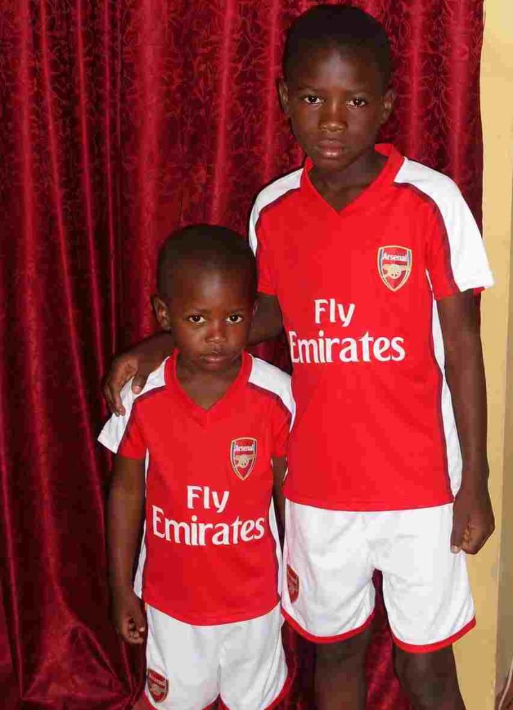 A 2009 picture of Abah Israel and his younger brother, Iwodi Joseph, kitted in Arsenal home jersey