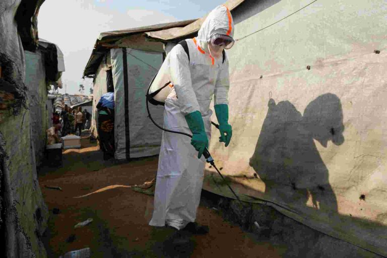 Ebola Outbreak Could Cost Africa Up To $3.6bn, UN Says A health worker in full personal protective equipment (PPE) disinfects an area