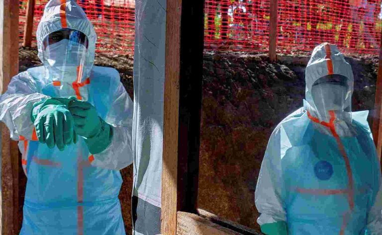 More Than 70 Congo Medics Infected With Ebola Since Outbreak Started, WHO Says Health workers get dressed in personal protective equipment (PPE)