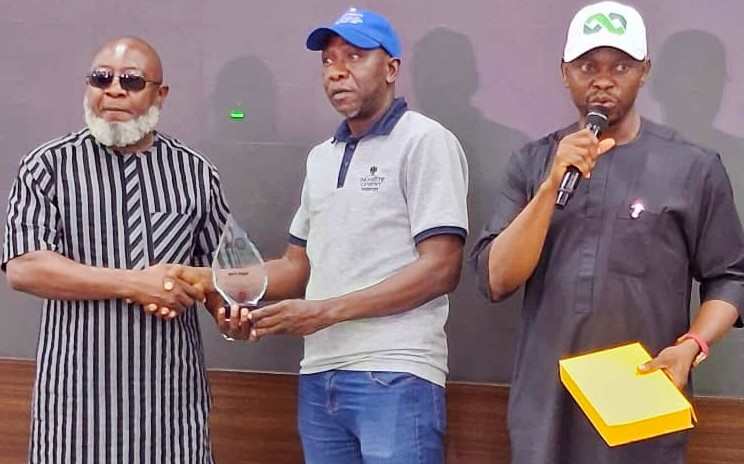 Road Safety Advocacy: Dangote Wins Corporate Excellence Award Assistant Divisional Director, Dangote Cement Transport, Mr. Abdullahi Aliyu (middle) receiving the award from the Kogi State Commissioner for Transport, Hon. Atuluku Victor Levi (left) and Dr. Suberu Yusuf John, Special Adviser to the Kogi State Governor on Road Safety Matters (right)