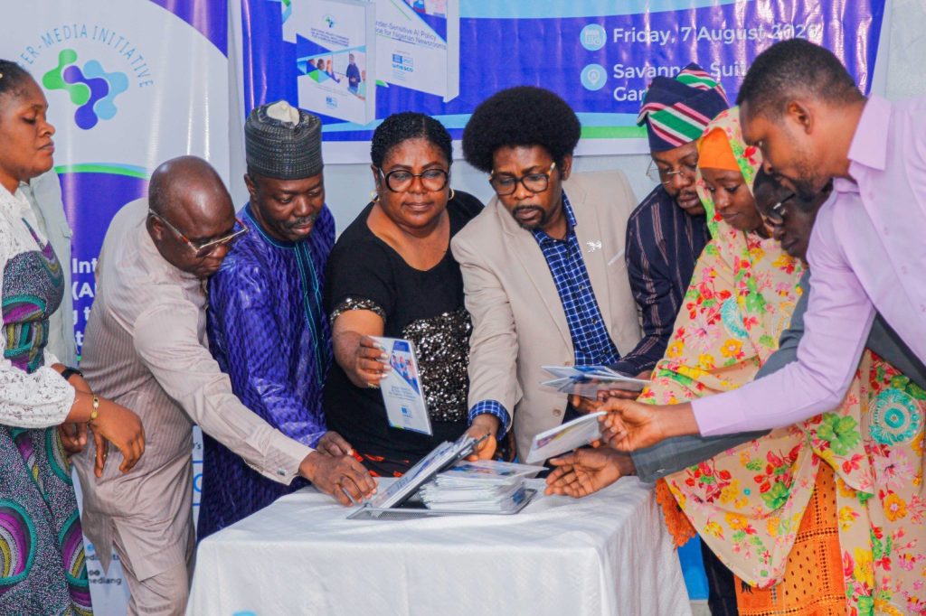 Participants pick copies of "Editorial Policy Guidance On Artificial Intelligence For Nigerian Newsrooms" following its unveiling.